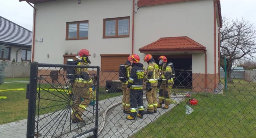 Na zdjęciu strażacy przed domem, w którym doszło do pożaru, fot. KP PSP Radomsko