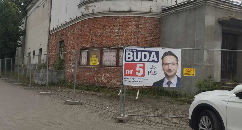 Na zdjęciu plakat kandydata na ogrodzeniu Kinemy